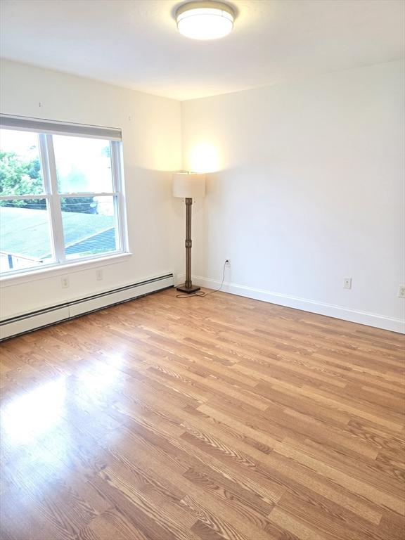 315 Cambridge St Unit 302A, Worcester, MA 01603 - unfurnished room featuring light wood-style floors and baseboard heating