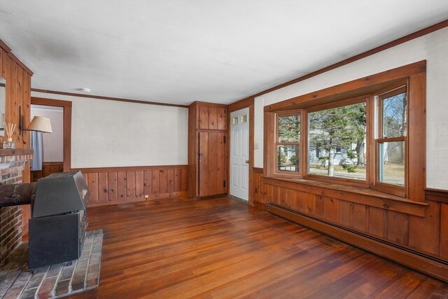 25 Charlotte Ave, Barnstable, MA 02635 - unfurnished living room with a wainscoted wall, a baseboard heating unit, and wood finished floors