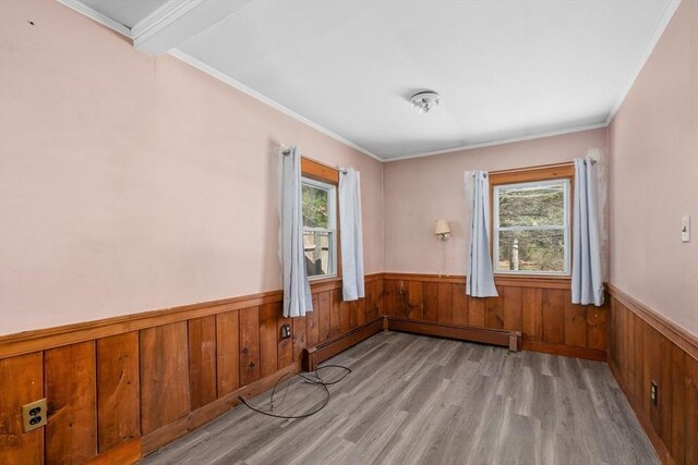25 Charlotte Ave, Barnstable, MA 02635 - unfurnished room with a baseboard heating unit, light wood-type flooring, a wainscoted wall, and a healthy amount of sunlight