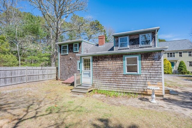 25 Charlotte Ave, Barnstable, MA 02635 - rear view of property with a yard, fence, and a chimney