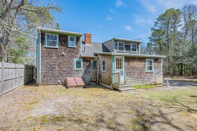 25 Charlotte Ave, Barnstable, MA 02635 - back of property with a chimney and fence
