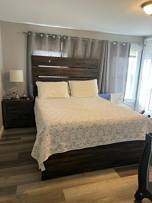 bedroom with dark hardwood / wood-style flooring