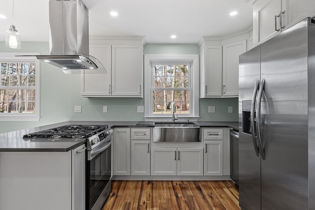 kitchen featuring stainless steel appliances, island range hood, dark wood-type flooring, sink, and white cabinetry