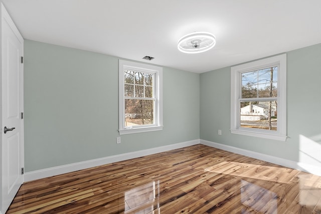 unfurnished room featuring hardwood / wood-style flooring