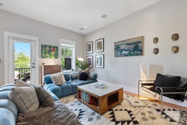 living area with light wood finished floors, baseboards, and recessed lighting