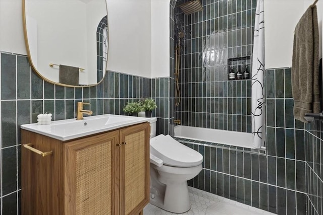 full bathroom with tile walls, toilet, vanity, tile patterned flooring, and tiled shower / bath