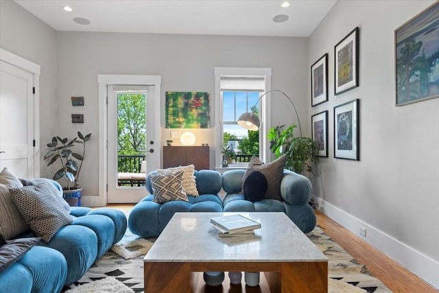 living area with plenty of natural light, baseboards, light wood-style flooring, and recessed lighting