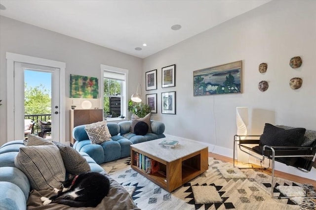 living area featuring baseboards and light wood-style flooring