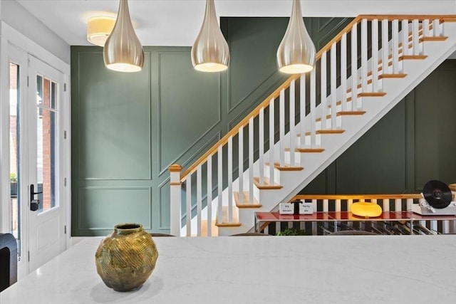 entryway featuring a decorative wall and stairway