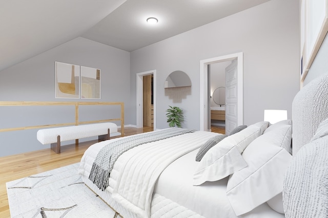 bedroom featuring vaulted ceiling, hardwood / wood-style floors, and ensuite bathroom