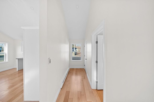 corridor with a baseboard radiator and light wood-type flooring