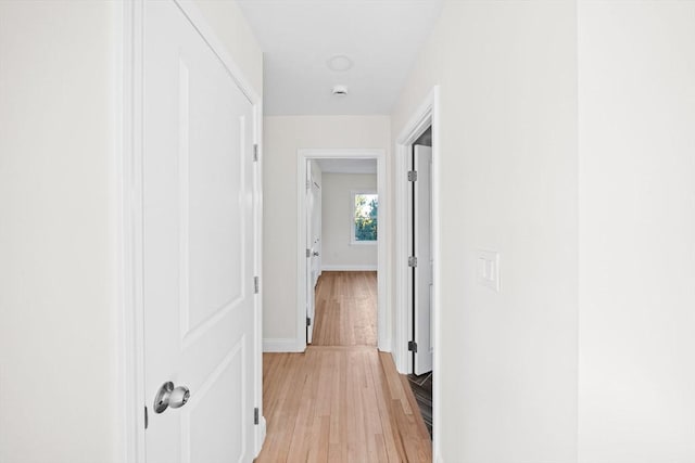 hallway with light hardwood / wood-style flooring