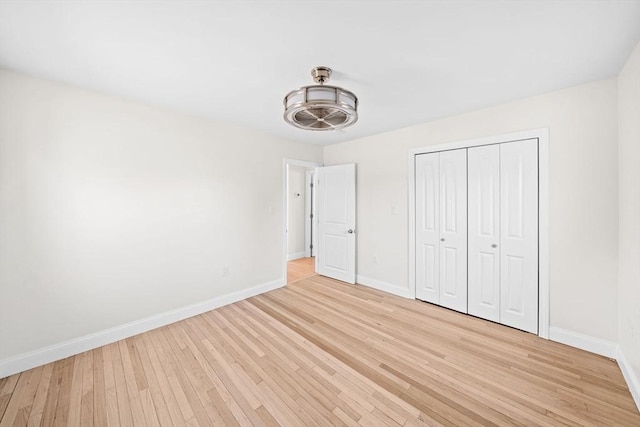 unfurnished bedroom featuring a closet and light hardwood / wood-style floors