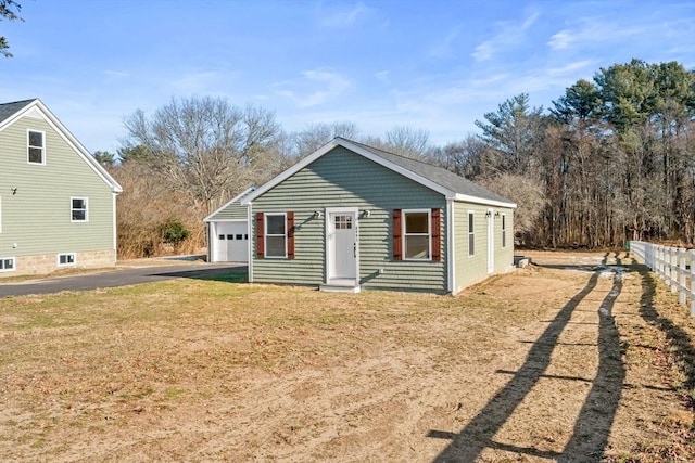 view of front of property with a garage and a front lawn