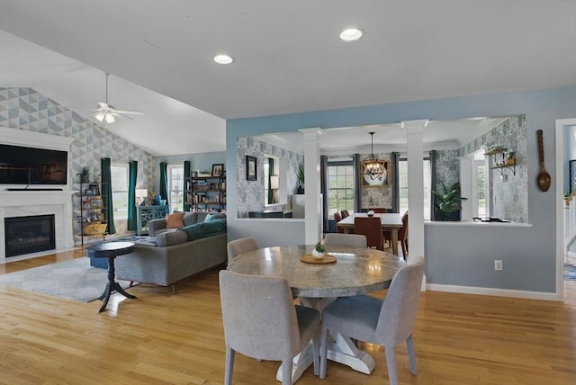 73 Sparrow Way, Raynham, MA 02767 - dining space with decorative columns, an accent wall, a premium fireplace, baseboards, and wallpapered walls