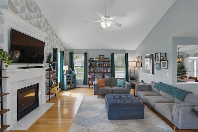 73 Sparrow Way, Raynham, MA 02767 - living area with high vaulted ceiling, a high end fireplace, a ceiling fan, and light wood-style floors