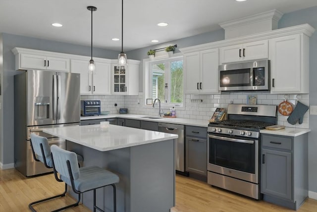 73 Sparrow Way, Raynham, MA 02767 - kitchen featuring light wood finished floors, white cabinetry, appliances with stainless steel finishes, and a sink