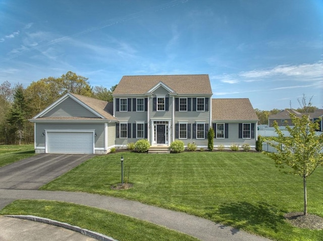 73 Sparrow Way, Raynham, MA 02767 - colonial home with an attached garage, roof with shingles, driveway, and a front lawn