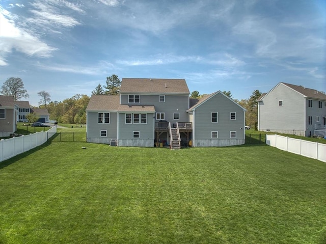 73 Sparrow Way, Raynham, MA 02767 - back of house with stairway, a deck, a fenced backyard, and a lawn