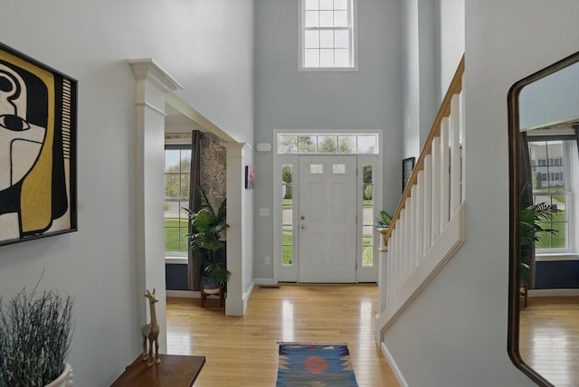 73 Sparrow Way, Raynham, MA 02767 - entryway with stairway, a towering ceiling, baseboards, and light wood-style floors