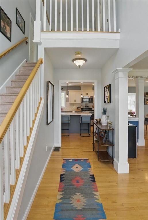 73 Sparrow Way, Raynham, MA 02767 - interior space featuring a towering ceiling, light wood-type flooring, visible vents, stairway, and baseboards