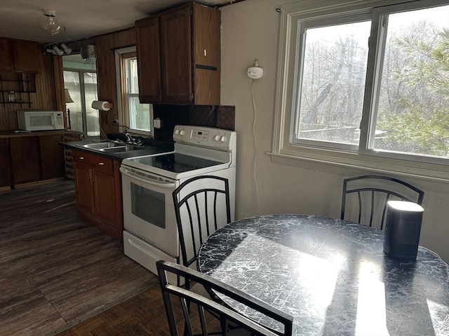 kitchen with a wealth of natural light, sink, and white appliances