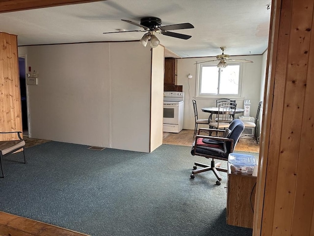 unfurnished office with ceiling fan and carpet