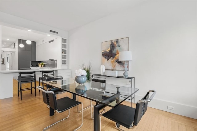 dining space with light hardwood / wood-style flooring