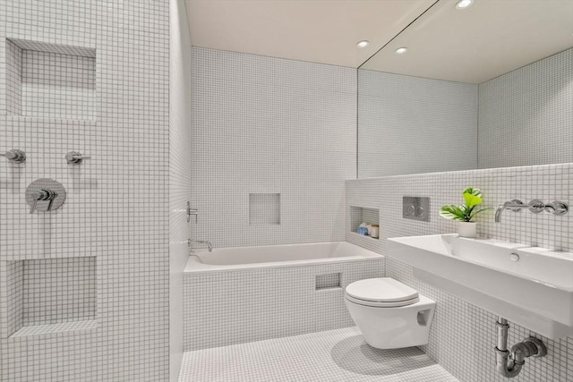 bathroom with toilet, tile patterned flooring, tile walls, and plus walk in shower