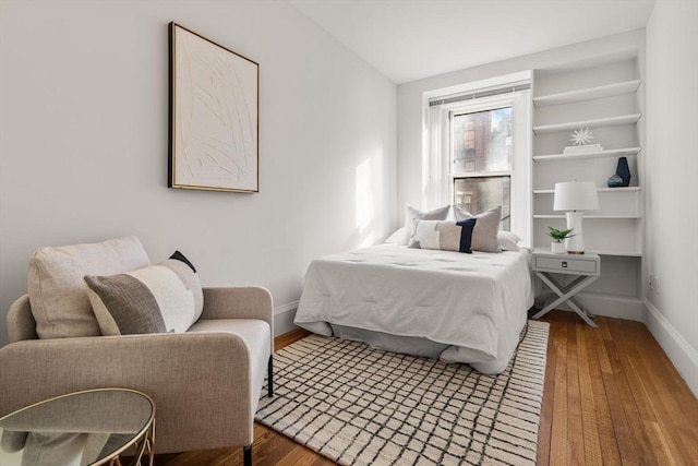 bedroom with hardwood / wood-style floors and vaulted ceiling