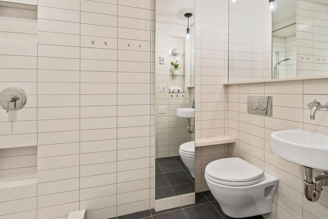 bathroom with tile walls, walk in shower, tile patterned flooring, and toilet