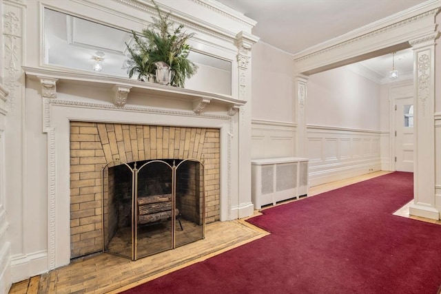 carpeted living room with a brick fireplace and ornamental molding