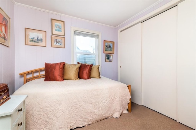 bedroom featuring light carpet, a closet, and ornamental molding