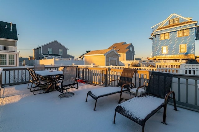 snow covered patio featuring a deck