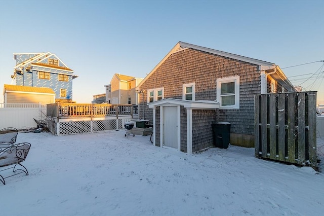 snow covered property with a deck