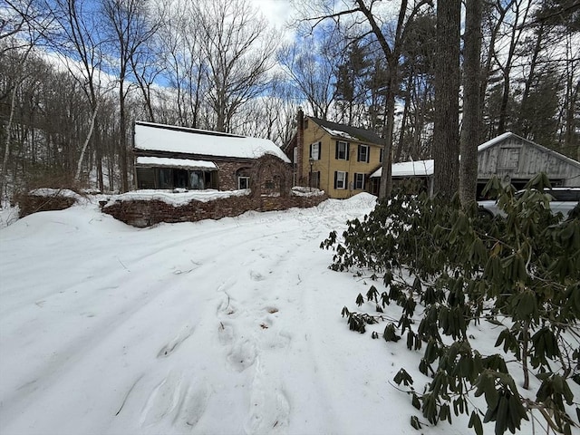 snow covered property with a garage