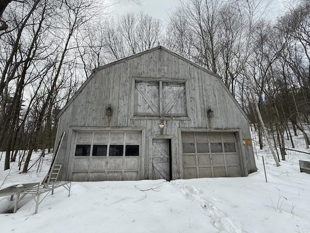 snow covered garage with a garage