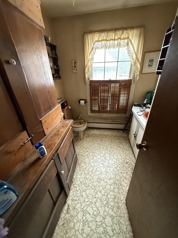 bathroom with a baseboard heating unit and toilet