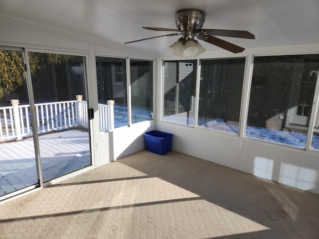 unfurnished sunroom featuring vaulted ceiling and ceiling fan