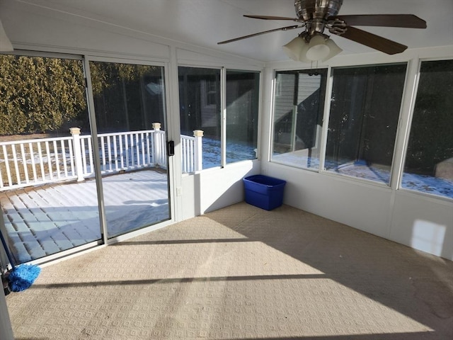 unfurnished sunroom with vaulted ceiling and ceiling fan