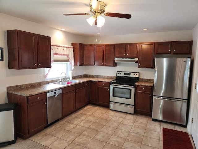 kitchen featuring light tile patterned flooring, appliances with stainless steel finishes, sink, and ceiling fan