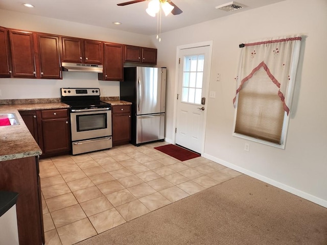 kitchen with ceiling fan, stainless steel appliances, and light tile patterned floors