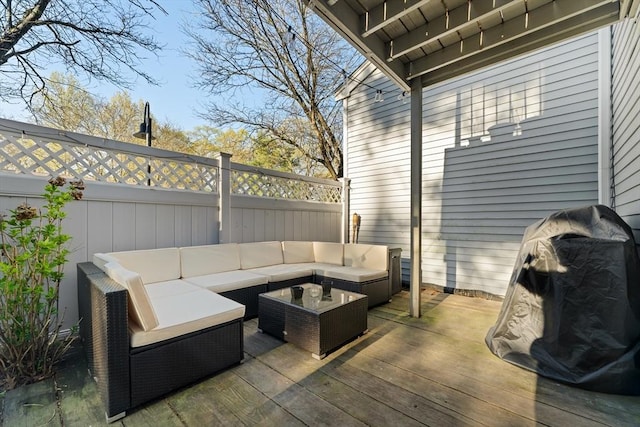 wooden terrace with fence and an outdoor hangout area