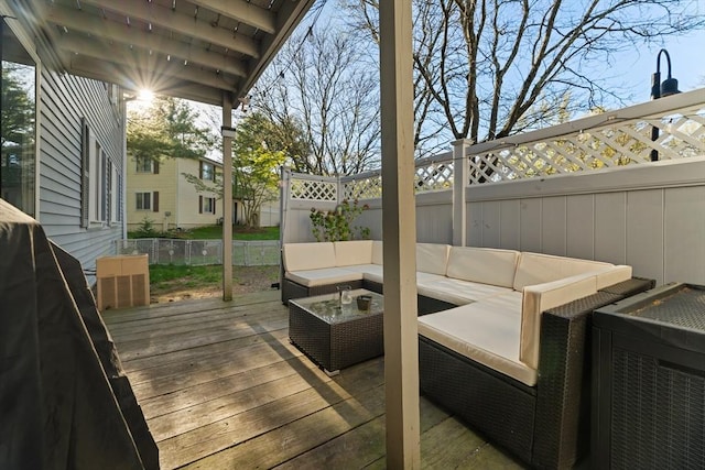 wooden deck featuring outdoor lounge area and a fenced backyard