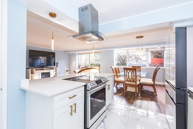 kitchen with white cabinets, crown molding, appliances with stainless steel finishes, decorative light fixtures, and island range hood