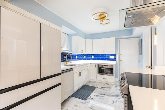 kitchen with decorative backsplash, white cabinetry, sink, and stainless steel appliances