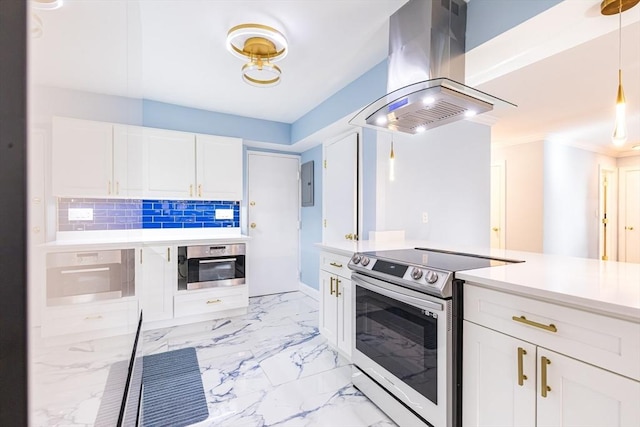 kitchen featuring island exhaust hood, appliances with stainless steel finishes, white cabinets, and tasteful backsplash