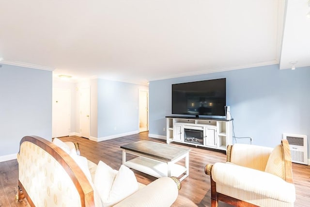 living room with hardwood / wood-style flooring and crown molding