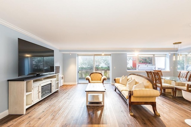 living room with light hardwood / wood-style flooring and ornamental molding