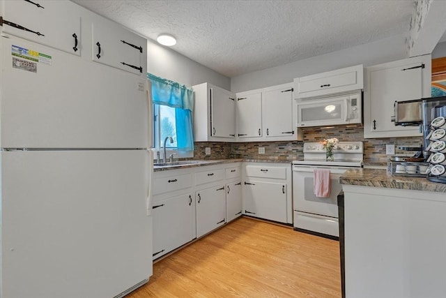 14 Cottage St, Whitman, MA 02382 - kitchen with white appliances, white cabinetry, backsplash, a textured ceiling, and light wood-style floors